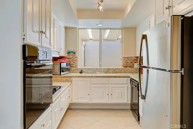 a white refrigerator freezer sitting inside of a kitchen