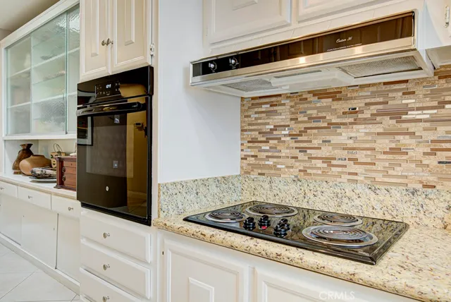 a close view of kitchen stove microwave and cabinets
