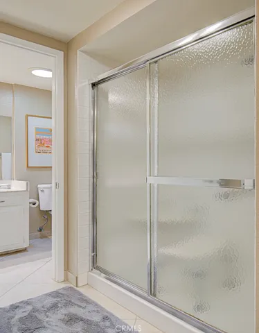 a bathroom with a granite countertop sink mirror vanity and toilet