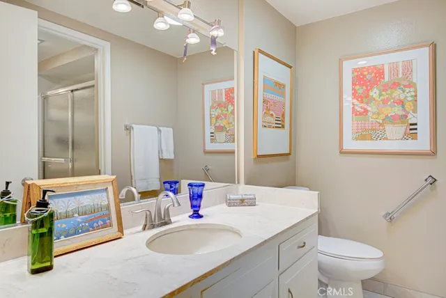 a bathroom with a shower sink and toilet