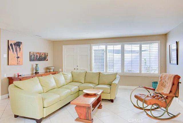 a living room with furniture a couch and a window