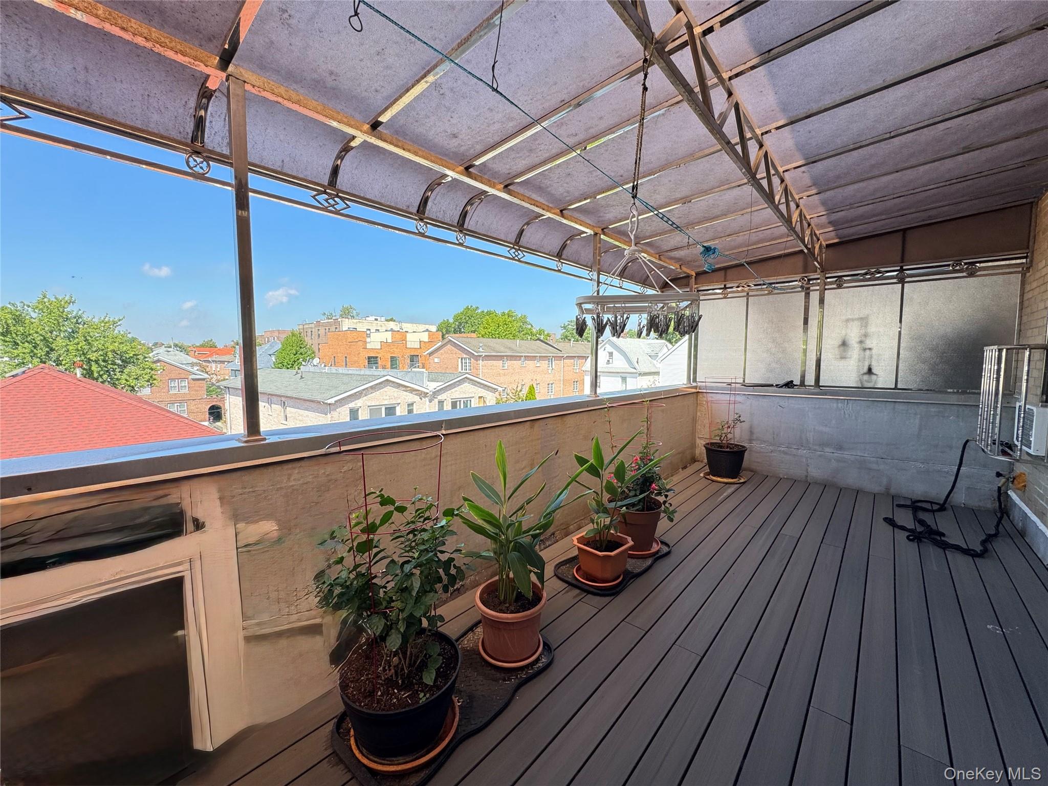 42-16 162nd Street Queens, NY 11358 - Photo 11 of 16 Unfurnished sunroom with a residential view