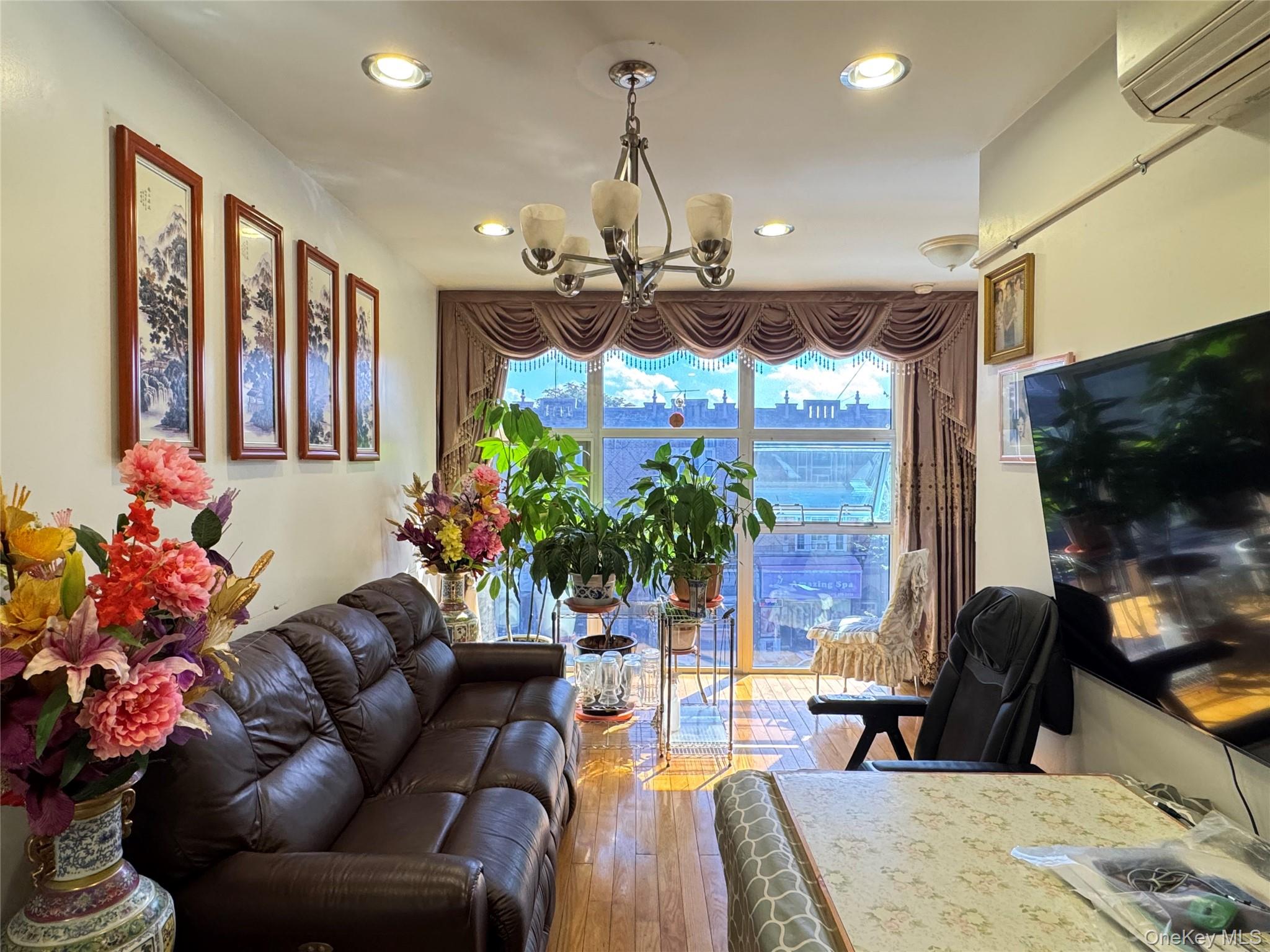 42-16 162nd Street Queens, NY 11358 - Photo 2 of 16 Living area with hardwood / wood-style flooring, recessed lighting, and a wall mounted AC