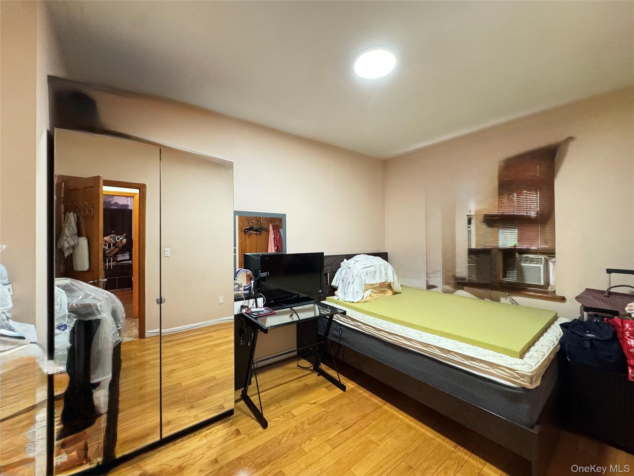 42-16 162nd Street Queens, NY 11358 - Photo 7 of 16 Bedroom featuring light wood-type flooring and a closet