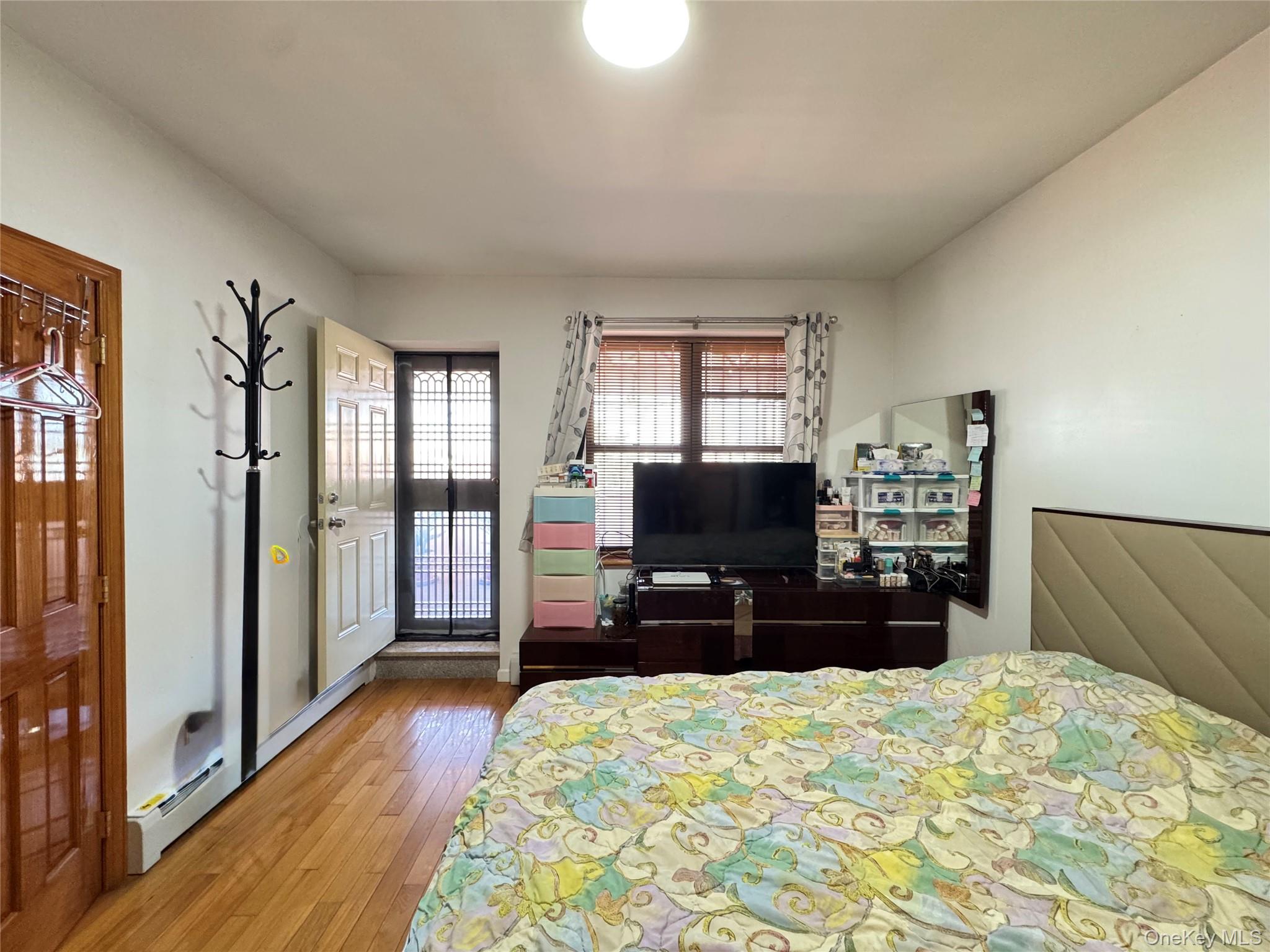 42-16 162nd Street Queens, NY 11358 - Photo 9 of 16 Bedroom with hardwood / wood-style flooring and baseboard heating