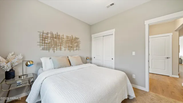 a bathroom with a granite countertop toilet sink and mirror