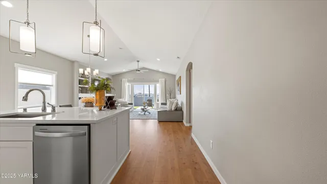 a kitchen with granite countertop a sink cabinets and stainless steel appliances