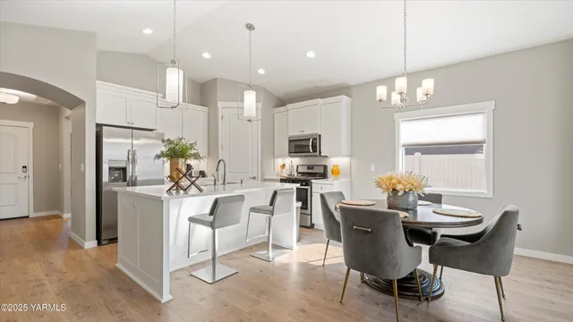 a living room with furniture a dining table and chairs