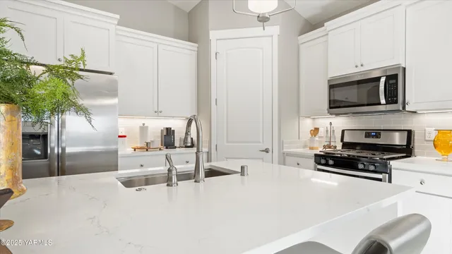 a view of living room with furniture and a chandelier