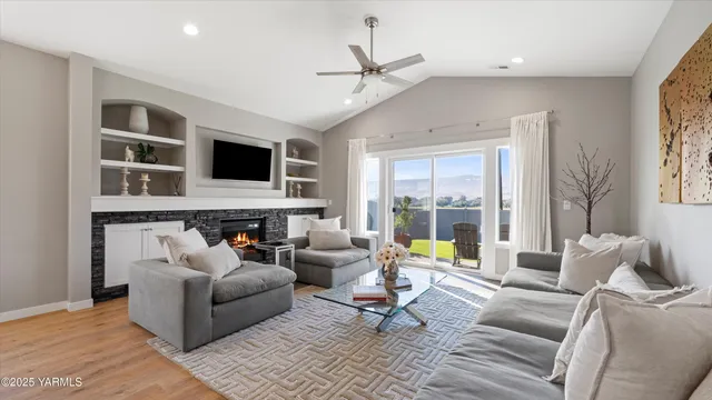 a living room with a fireplace and a flat screen tv