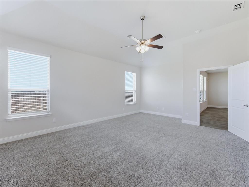 1121 Knightsbridge Road Argyle, TX 76226 - Photo 29 of 39 Spacious primary bedroom featuring neutral-toned carpet, light gray wall paint, and multiple windows with blinds