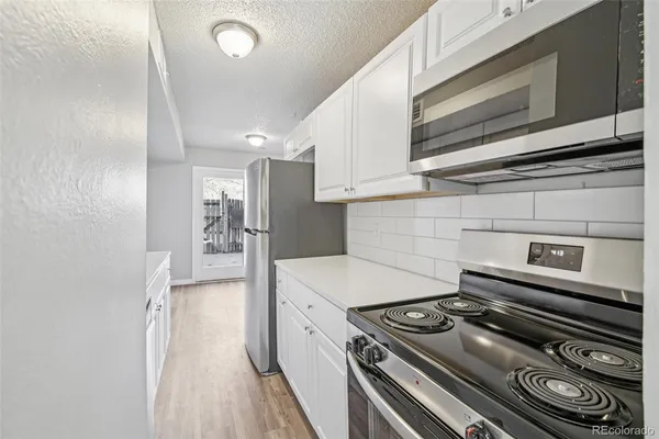 a kitchen with a stove and a refrigerator