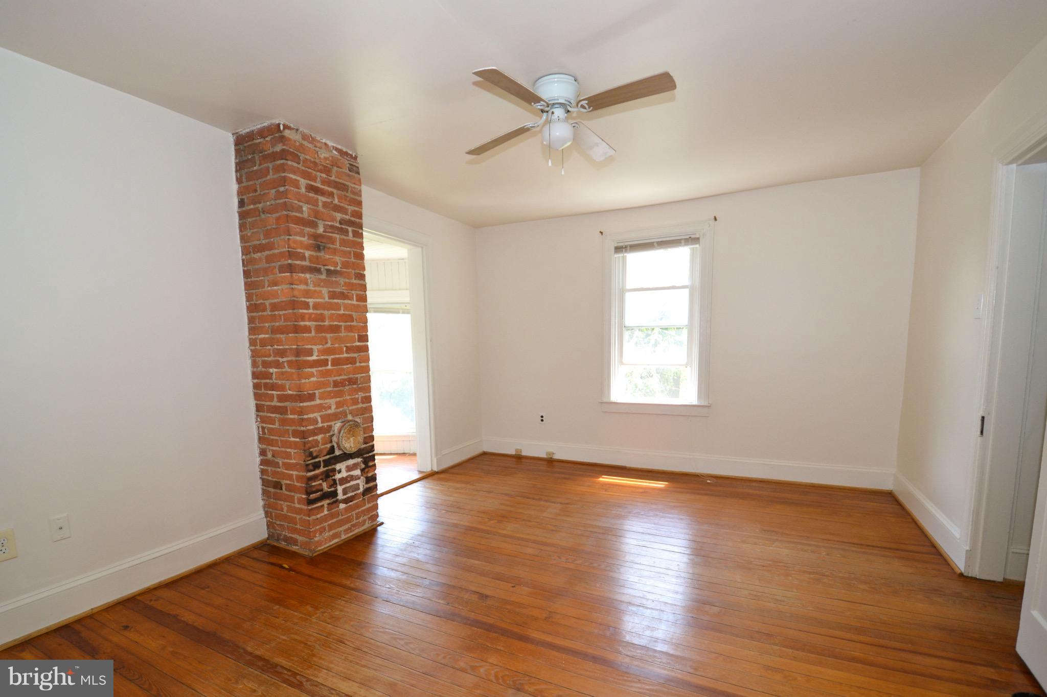 374 Jewell Road Dunkirk, MD 20754 - Photo 20 of 25 an empty room with wooden floor chandelier fan and windows
