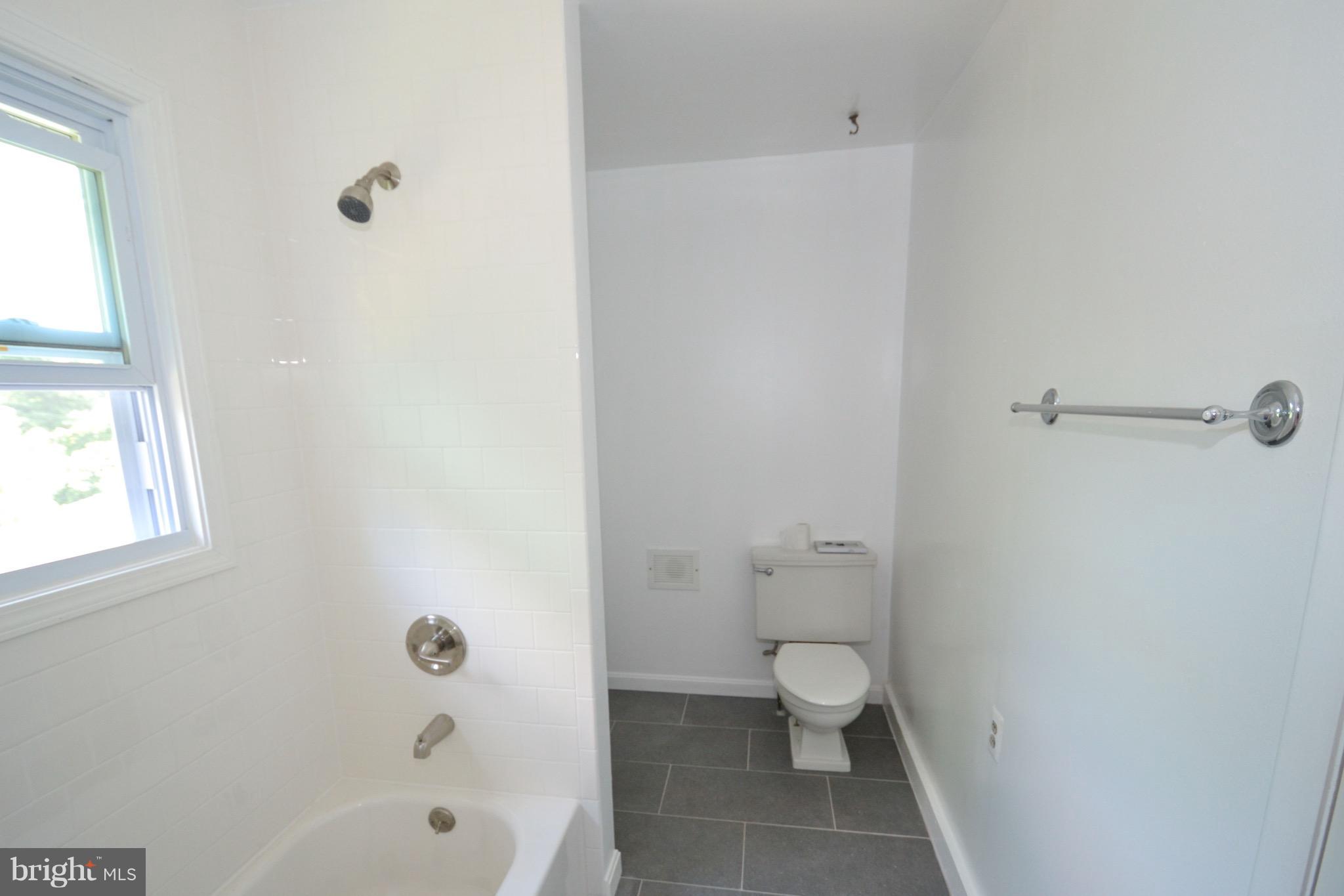374 Jewell Road Dunkirk, MD 20754 - Photo 23 of 25 a bathroom with a granite countertop toilet and a bathtub