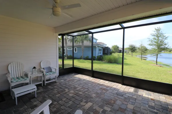 a view of a porch with chairs in backyard