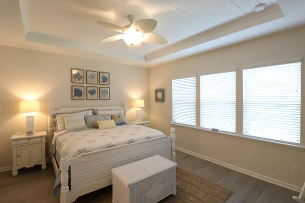 a bedroom with a large bed and a chandelier