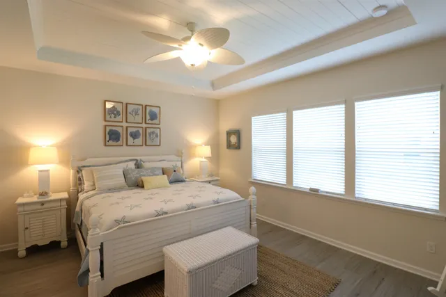 a bedroom with a large bed and a chandelier