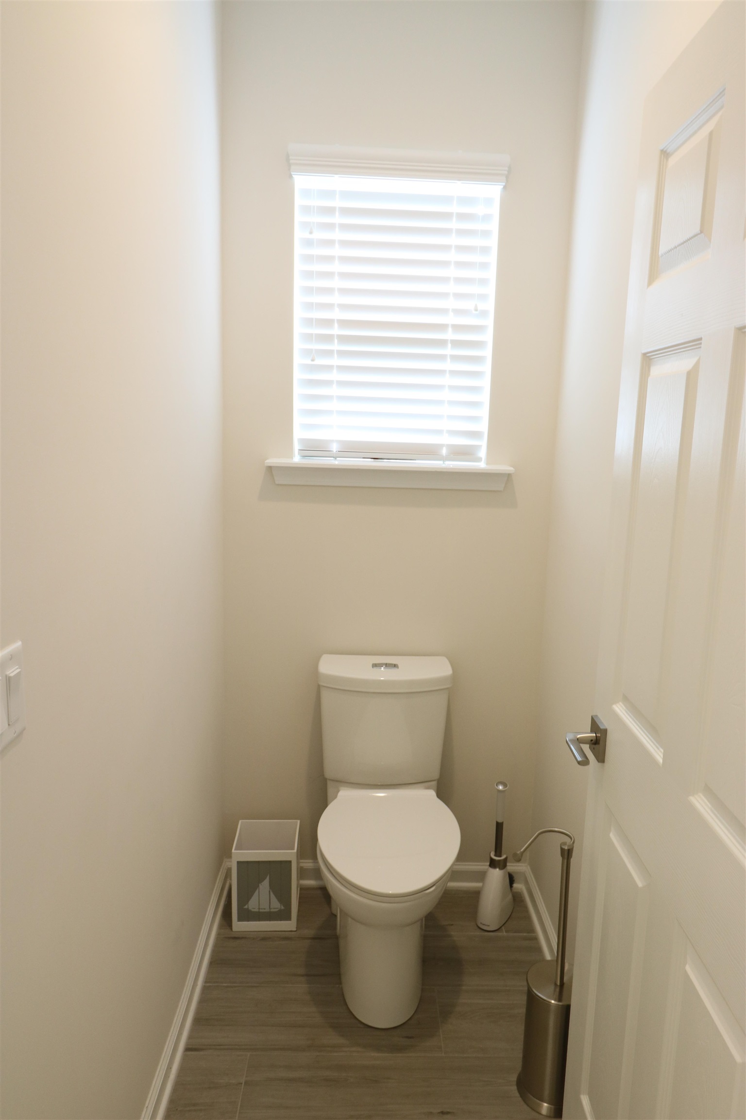 827 East Watson Road St. Augustine, FL 32086 - Photo 17 of 26 a white toilet sitting in a bathroom next to a window
