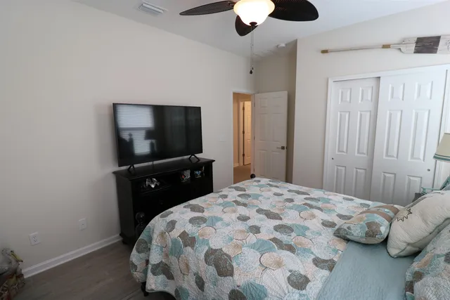a bedroom with a bed and a flat screen tv
