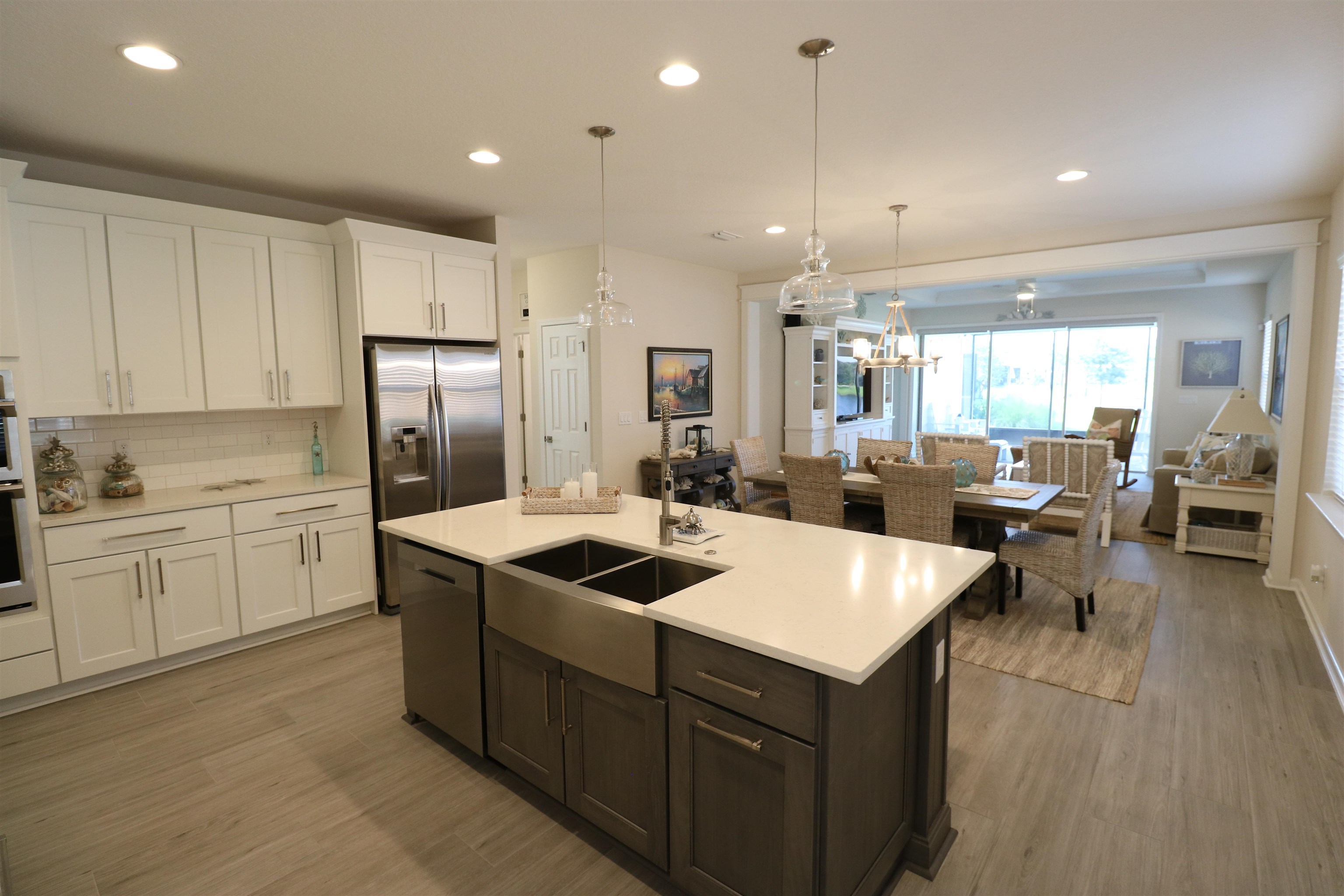 827 East Watson Road St. Augustine, FL 32086 - Photo 2 of 26 a kitchen that has a lot of cabinets a sink and a refrigerator in it