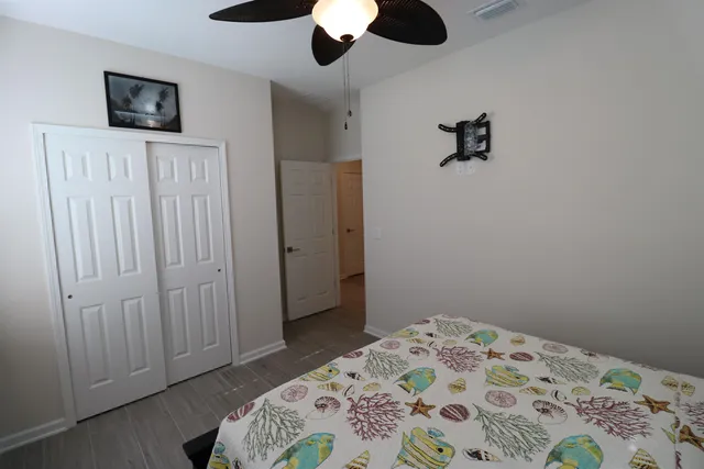 a bedroom with a bed and a chandelier