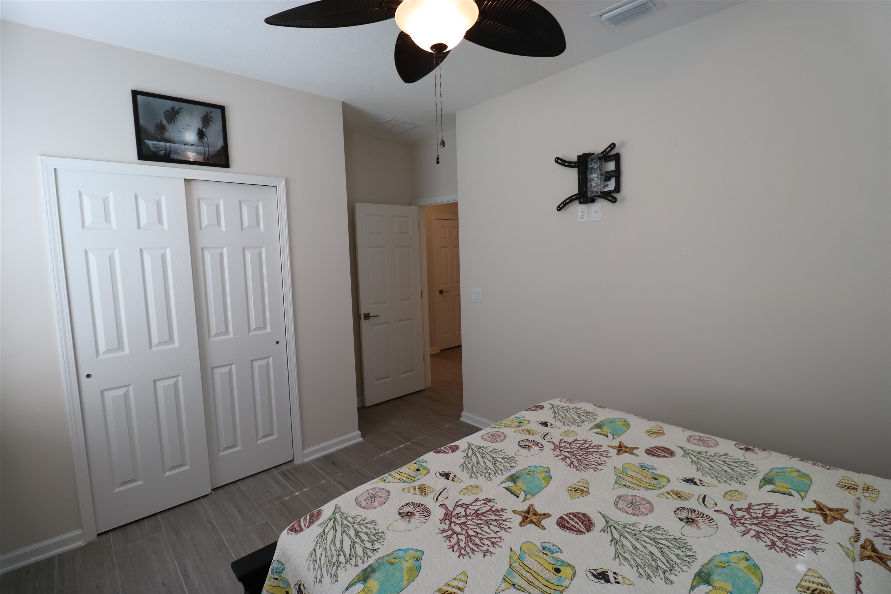 827 East Watson Road St. Augustine, FL 32086 - Photo 21 of 26 a bedroom with a bed and a chandelier