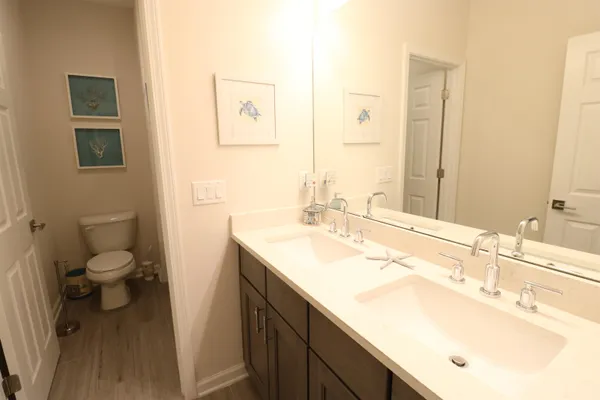 a bathroom with a sink toilet and a mirror