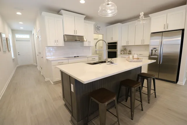 a kitchen with refrigerator cabinets and wooden floor