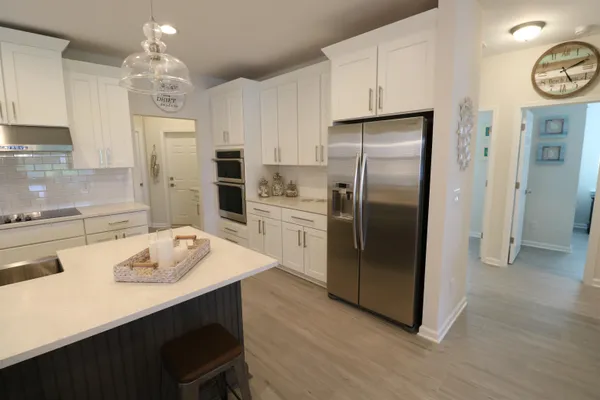 a kitchen with stainless steel appliances a refrigerator sink and stove