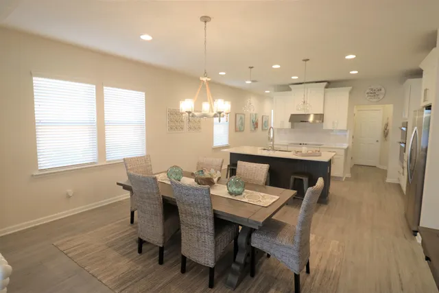 a dining room with stainless steel appliances kitchen island granite countertop furniture and a fireplace