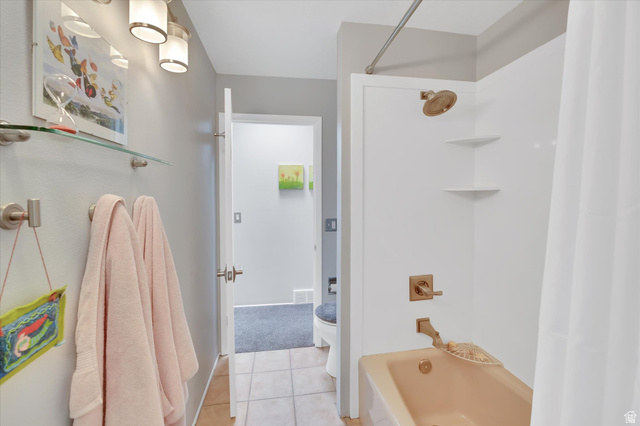 510 Spring Creek Road Providence, UT 84332 - Photo 23 of 97 Bathroom featuring a full shower/tub combination with gold-toned fixtures and a white surround