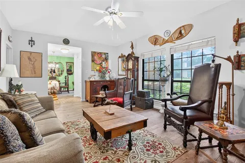 a living room with furniture a rug and a window