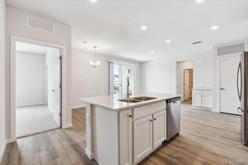 485 Interlocken Boulevard, Unit 210 Broomfield, CO 80021 - Photo 1 of 15 an open kitchen with a sink and refrigerator