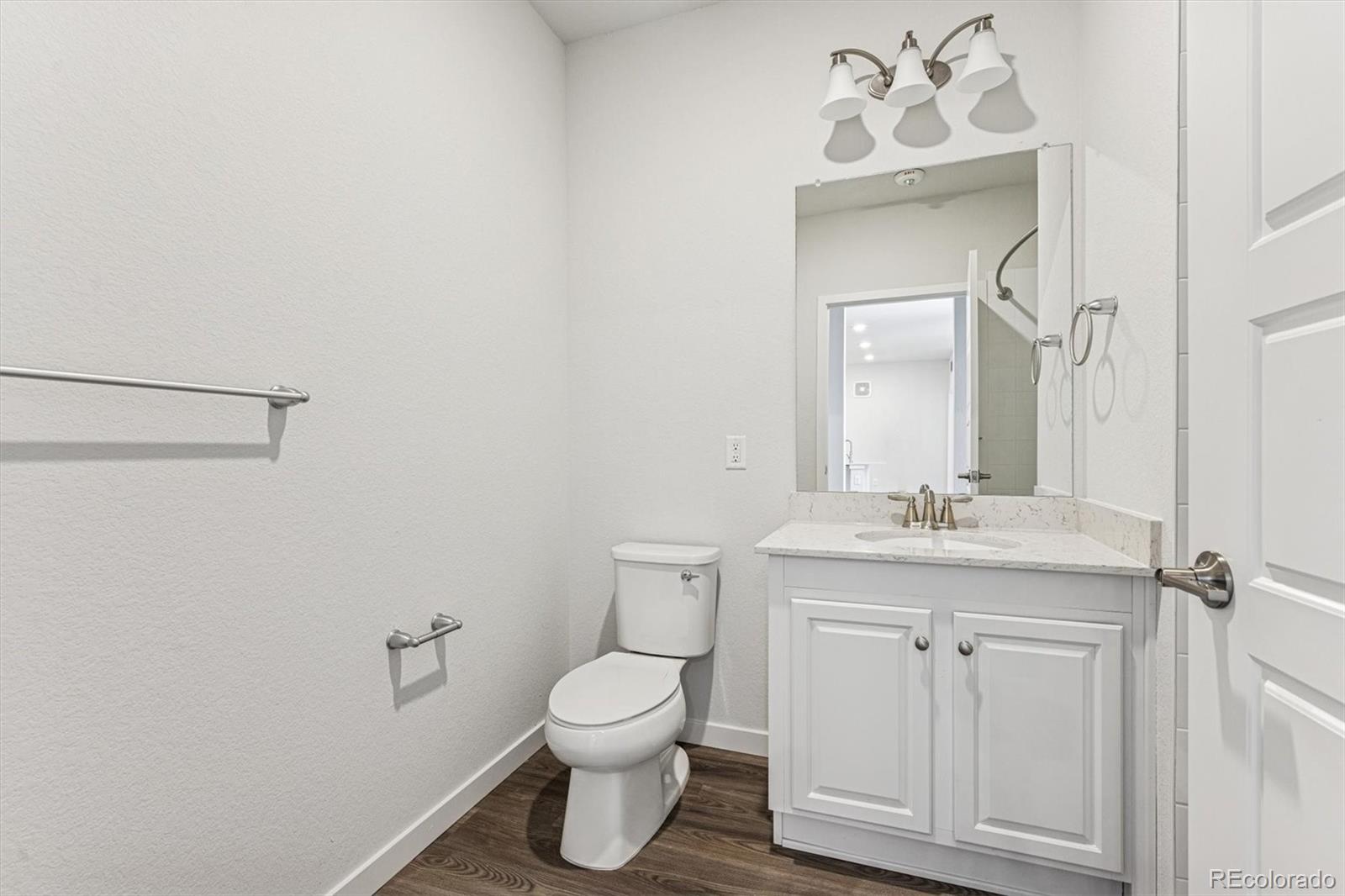 485 Interlocken Boulevard, Unit 210 Broomfield, CO 80021 - Photo 11 of 15 a bathroom with a toilet a sink and mirror