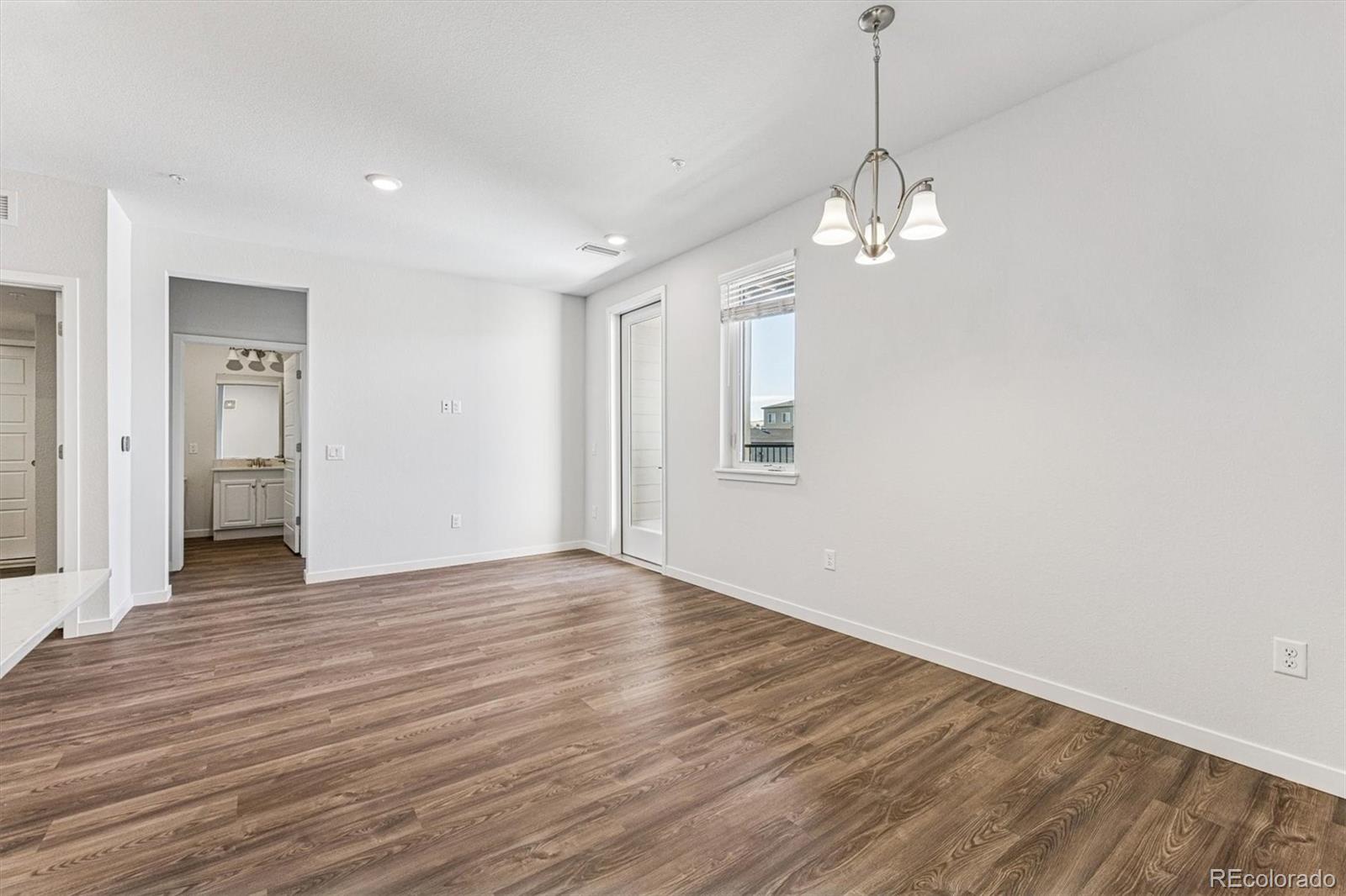 485 Interlocken Boulevard, Unit 210 Broomfield, CO 80021 - Photo 5 of 15 a view of empty room with wooden floor and ceiling fan