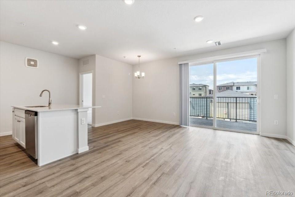 485 Interlocken Boulevard, Unit 210 Broomfield, CO 80021 - Photo 6 of 15 a view of an empty room with wooden floor and a window