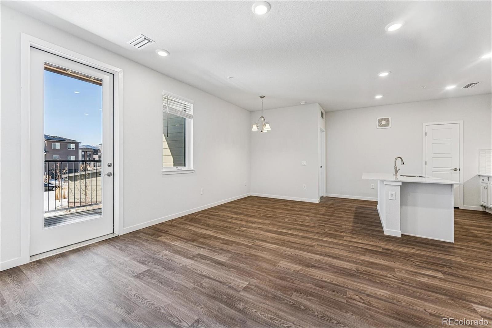 485 Interlocken Boulevard, Unit 210 Broomfield, CO 80021 - Photo 6 of 15 a view of an empty room with wooden floor and a window