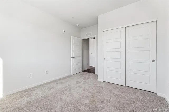an empty room with closet area