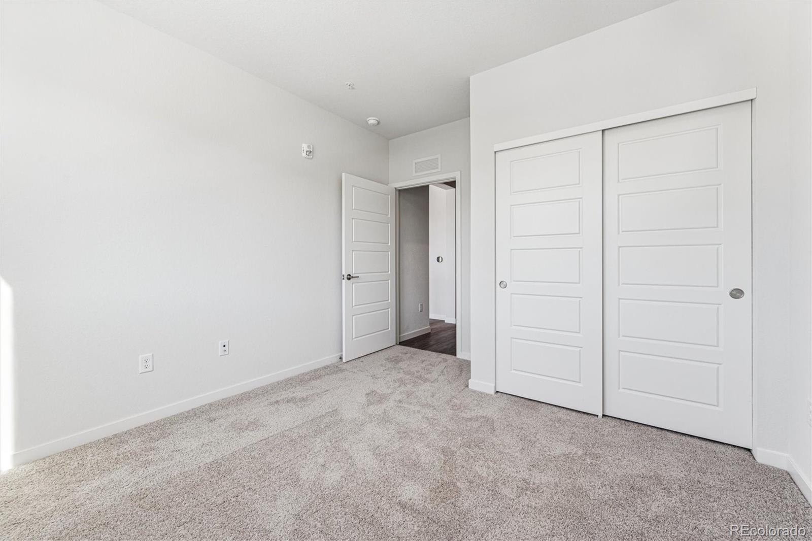 485 Interlocken Boulevard, Unit 210 Broomfield, CO 80021 - Photo 9 of 15 an empty room with closet area