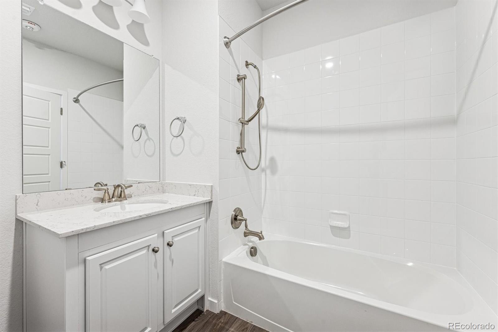 485 Interlocken Boulevard, Unit 210 Broomfield, CO 80021 - Photo 10 of 15 a bathroom with a tub sink vanity granite and shower