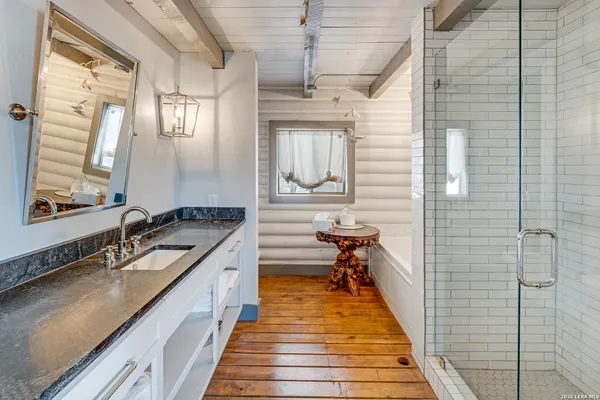 a dining room with furniture a rug and wooden floor