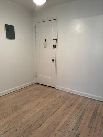 a view of an empty room with wooden floor