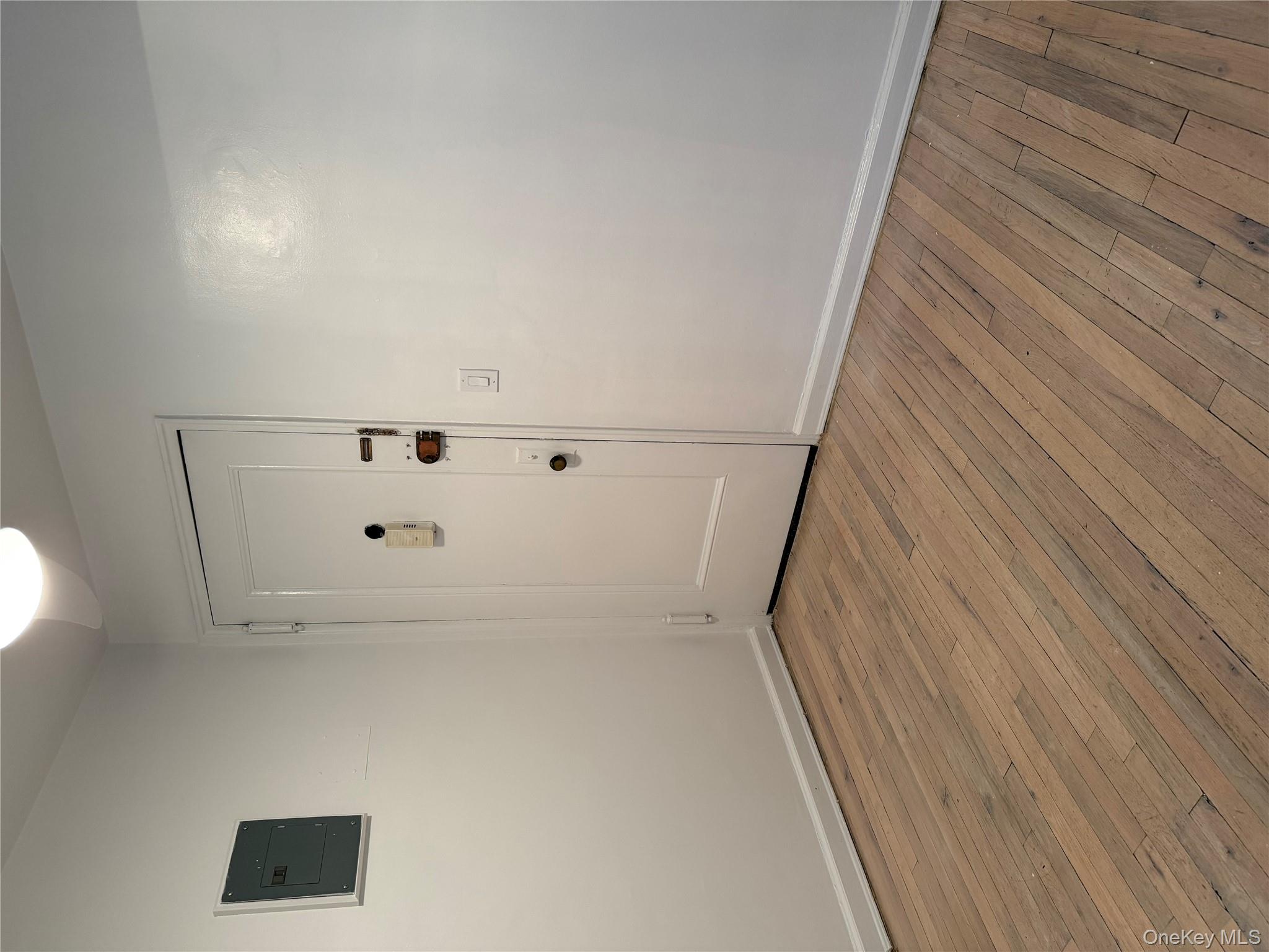 15 Canterbury Road, Unit D13 Great Neck, NY 11021 - Photo 5 of 9 a view of an empty room with wooden floor