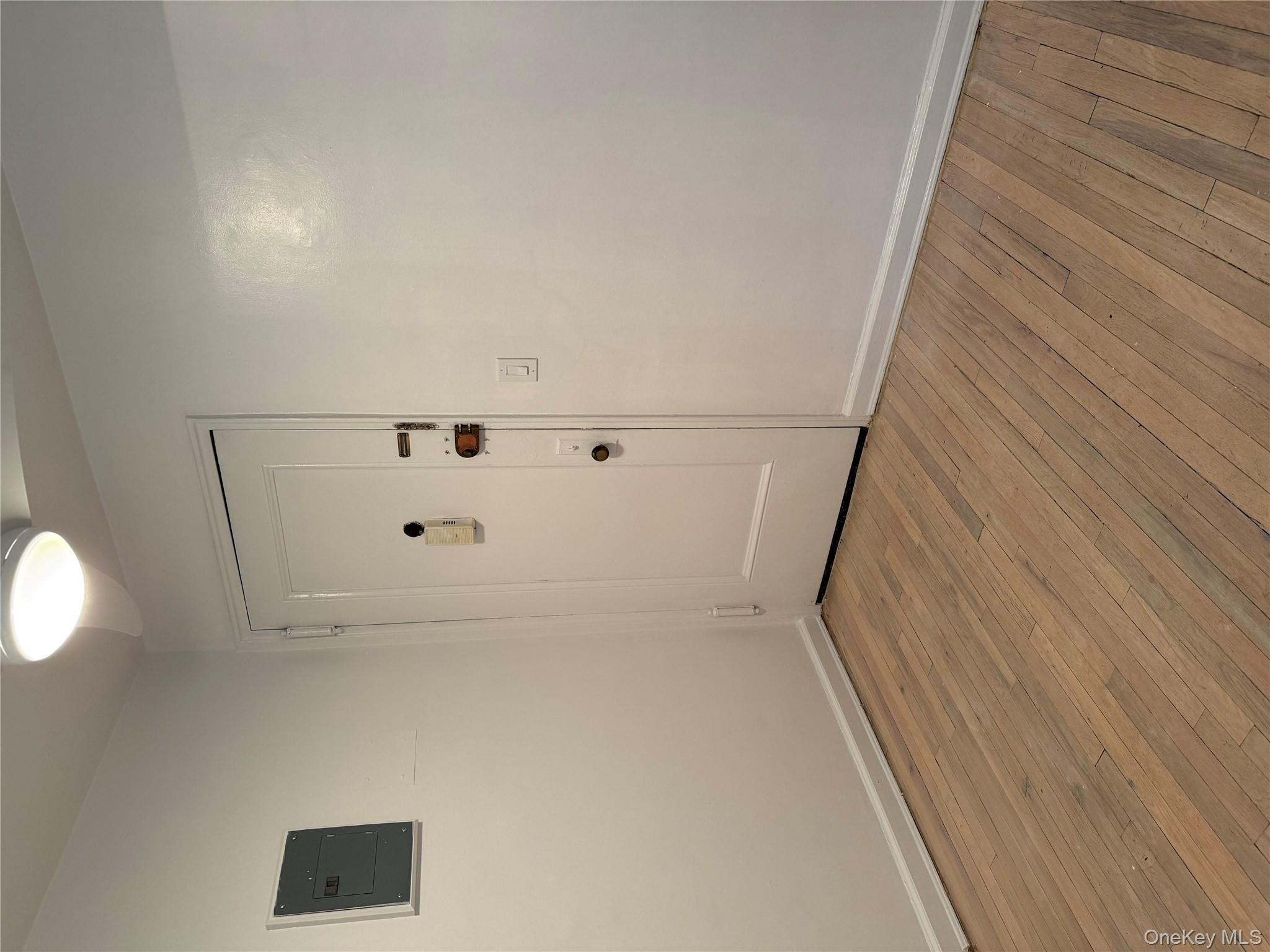 15 Canterbury Road, Unit D13 Great Neck, NY 11021 - Photo 7 of 9 a view of an empty room with wooden floor