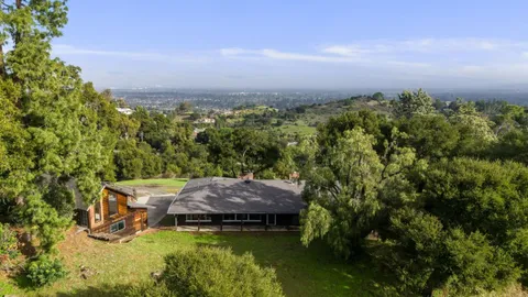 an aerial view of house with yard swimming pool and outdoor seating