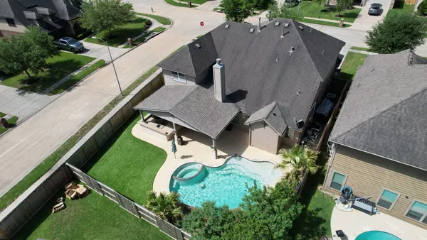 an aerial view of a house with a yard