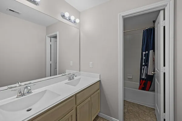 a bathroom with a sink vanity and a mirror