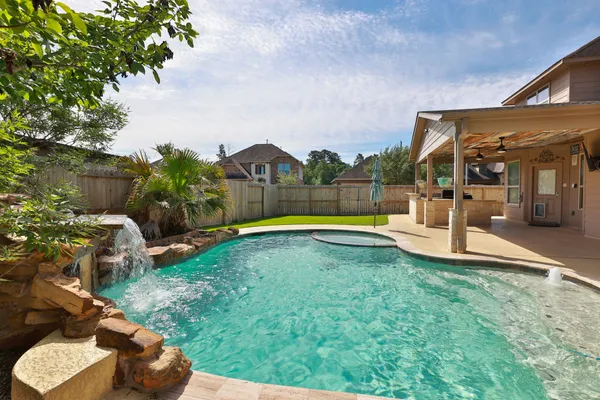 a view of a backyard with swimming pool