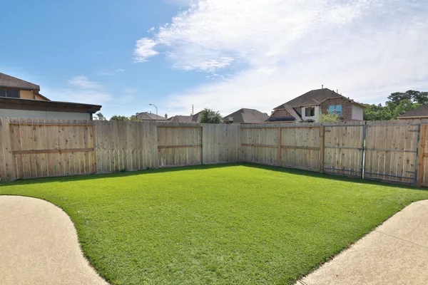 a view of a backyard with a garden and entertaining space