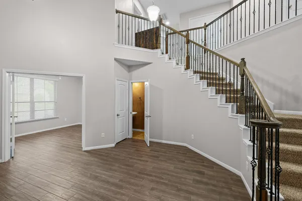 a view of entryway and hall with wooden floor